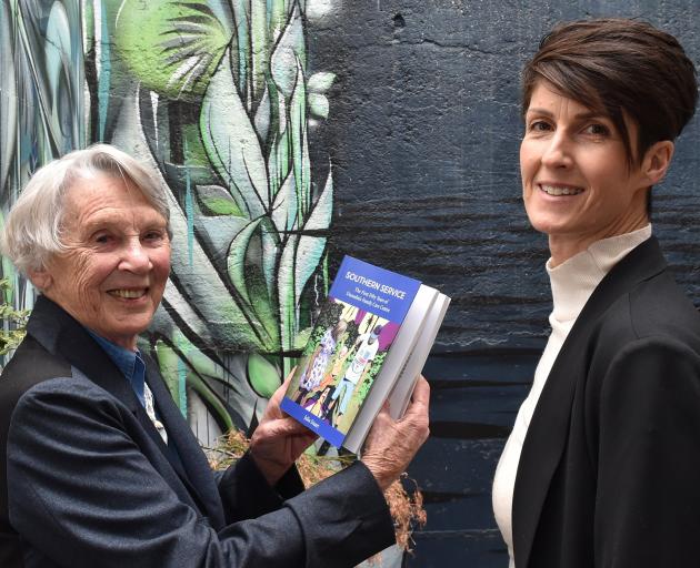 Julia Stuart shows her book Southern Service, which documents the history of Anglican Family Care...