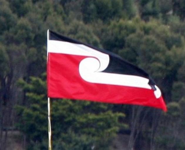 The Maori Tino Rangatiratanga flag flutters above Te Tii Reserve at Paihia as Waitangi Day...