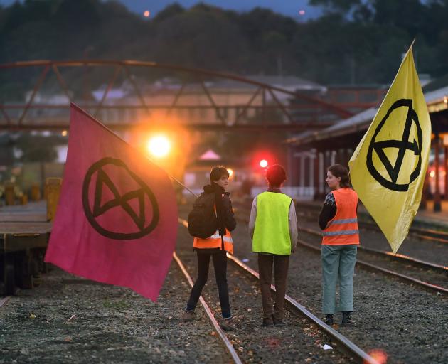 School pupils face off with a train transporting coal at the Dunedin Railway Station yesterday....