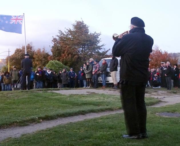 High winds added an extra layer of difficulty to the tasks of playing the Last Post and raising...