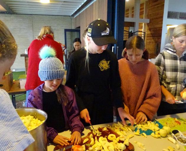 Chopping fruit for relish at the Wanaka Autumn Apple Drive at Rippon Hall on Saturday are (from...