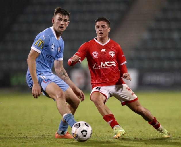 Cameron Devlin of the Phoenix competes with Connor Metcalfe of Melbourne City during their match...