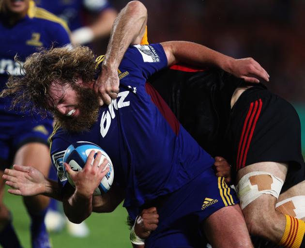 Highlanders hooker Liam Coltman looks to break a tackle against the Chiefs in Hamilton in 2013....