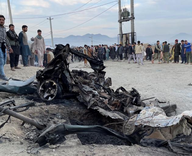 People stand at the site of a blast in Kabul. Photo: Reuters 