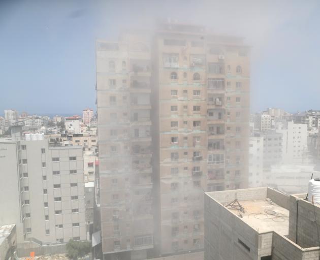 Dust and smoke rise following an Israeli air strike amid a flare-up of Israeli-Palestinian...