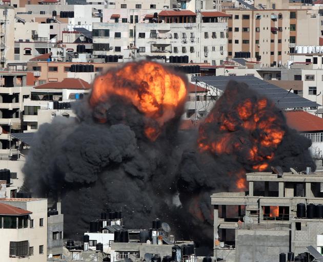 Smoke and flames rise during an Israeli air strike, amid a flare-up of Israeli-Palestinian violence, in Gaza City. Photo: Reuters