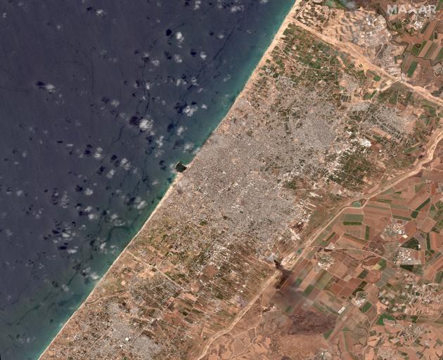 A satellite view shows aftermath of the damage in and around Gaza City after the past 11 days of...