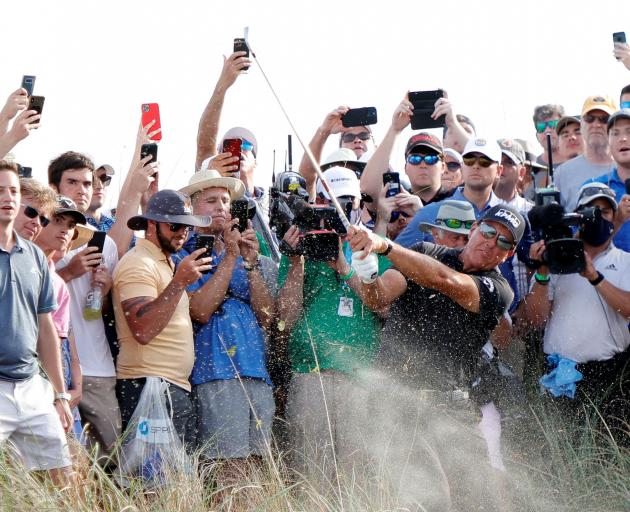 Phil Mickelson hits out of the rough on the sixteenth course during the third round of the PGA...