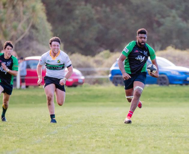 Barbarians forward Albert Qoro runs with the ball, pursued by Marist hooker Flynn Thomas, at Gore...