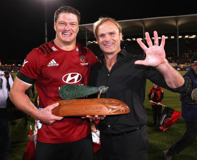 Crusaders’ captain Scott Barrett and coach Scott Robertson celebrate winning the Super Rugby...