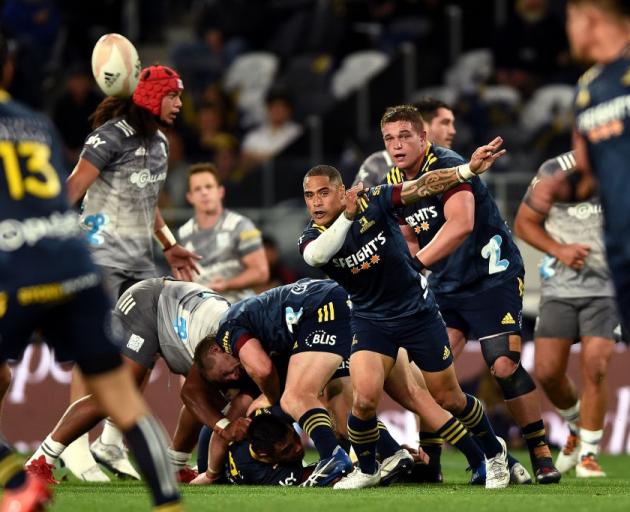 Highlanders halfback Aaron Smith clears the ball from a ruck against the Chiefs at Forsyth Barr...