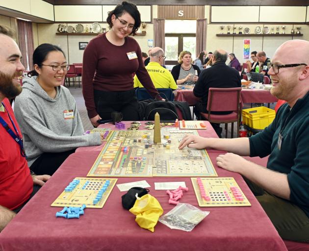 Chris Hay (right), of Dunedin, teaches Tekhenu to board game enthusiasts (from left) Matt...