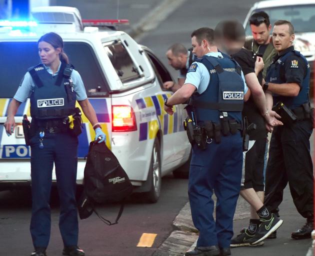 Dunedin police take a man into custody following an alleged theft in North Dunedin yesterday....