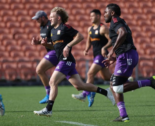 Damian McKenzie (centre) warms up during a Chiefs training session yesterday. Photo: Getty Images 