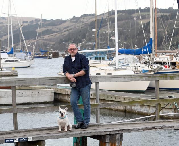 Sailor Chris King, of North Taieri, pictured with his dog Ted, backed calls for a harbour...