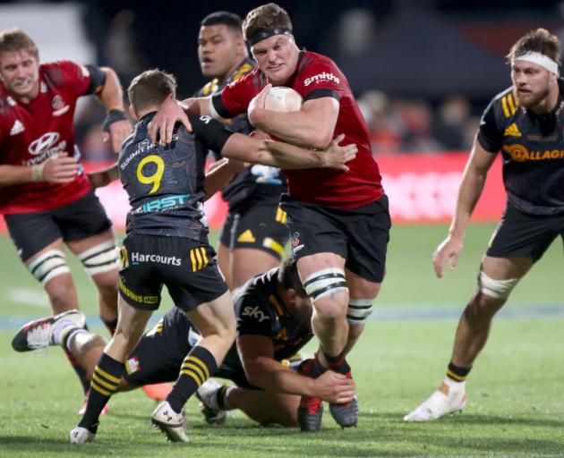 Crusaders captain Scott Barrett is tackled by Chiefs captain Brad Weber during Saturday's Super...