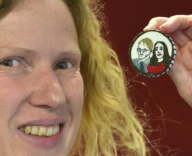 Jane McMillan with an Ashley Bloomfield and Jacinda Ardern brooch she designed for embroidering....