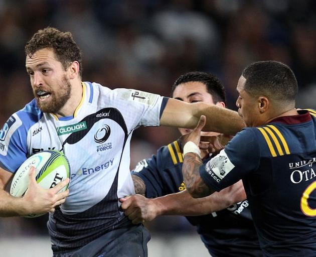 Luke Morahan tries to break the tackle of Aaron Smith when the Force played the Highlanders in...