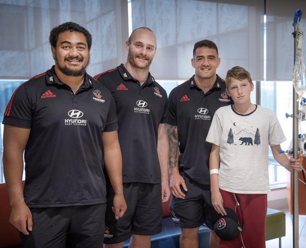 Isi Tu'ungafasi, Oliver Jager and Codie Taylor with a young patient. Photo: Supplied