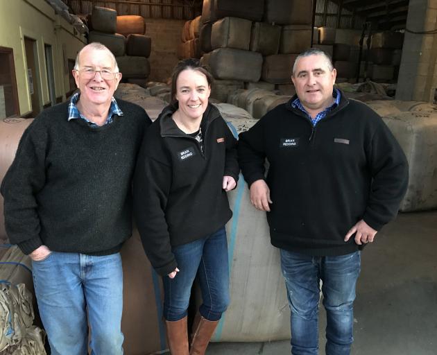 Jim Paterson (left), from wool buyer Brian Redding Ltd, and new owners Annie and Bede Chamberlain...