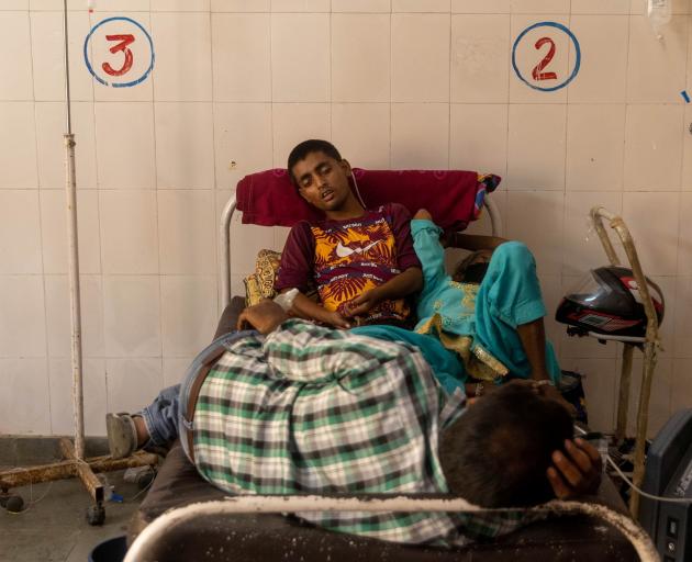 Patients receive treatment inside a Covid ward of a government-run hospital in Bijnor district,...