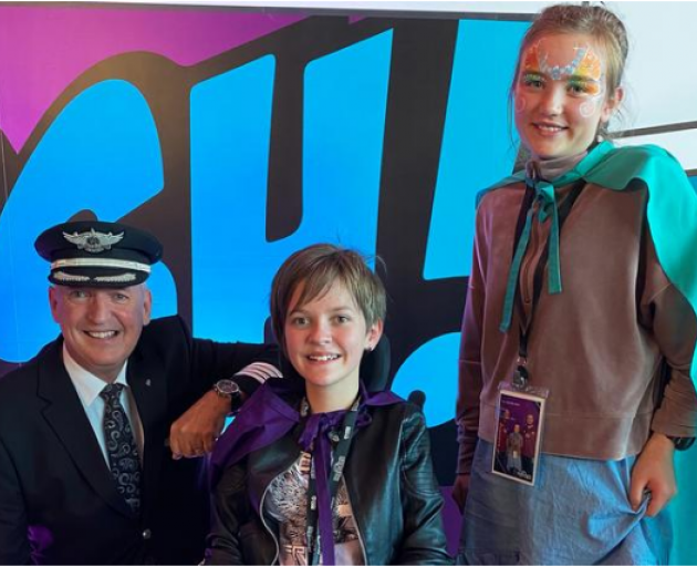 Air New Zealand chief pilot Captain David Morgan with Lilly, 12, and Annie, 11, before the flight...