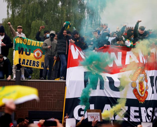 Manchester United fans protest against their American owners at Old Trafford on Sunday. Photo:...