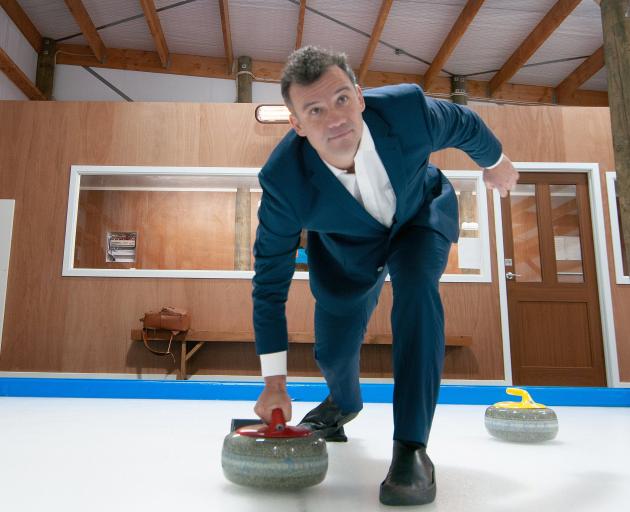Southland MP Joseph Mooney throws a stone at the new Alexandra Curling Rink. Mr Mooney was on...