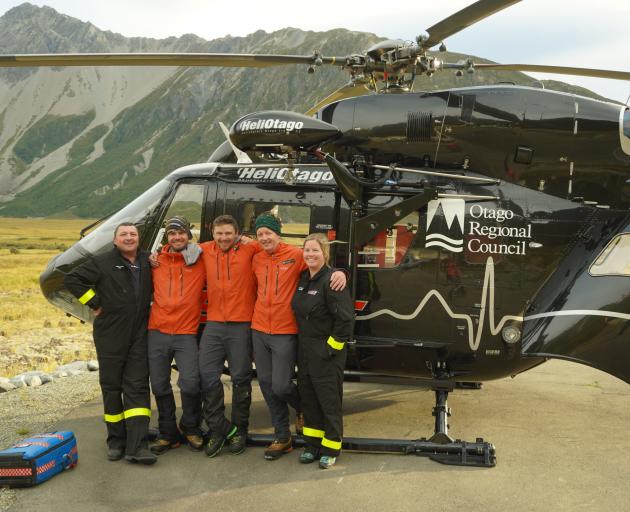 Celebrating the successful mission at the Mount Cook rescue base helipad are (from left) former...