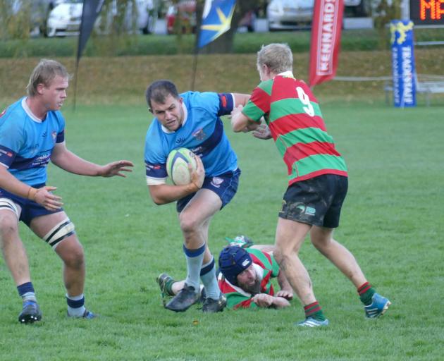 Wakatipu openside flanker Dave Fraser gives Matakanui Combined's Luke Hume the flick, with team...