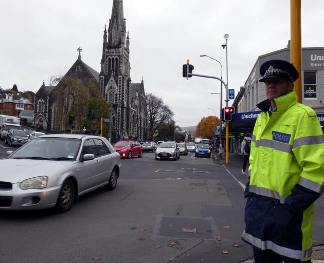 Senior Sergeant Craig Dinnissen, of Dunedin, observes vehicles at the intersection of George and...