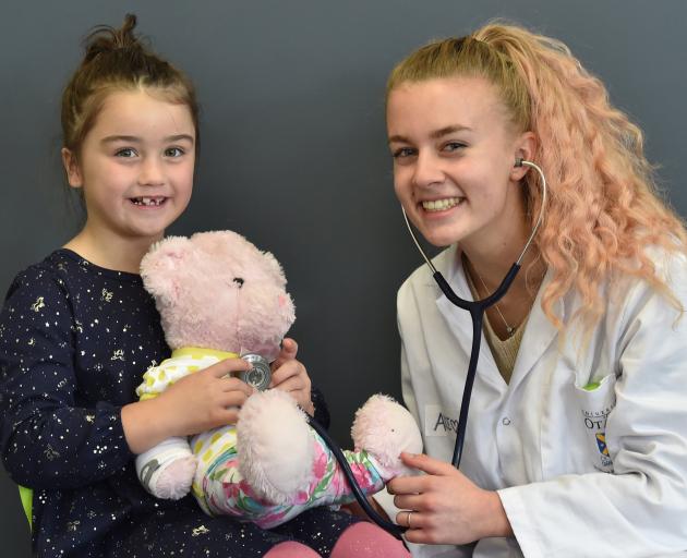 Ariana Kristel (6) holds her teddy Cookie for a check-up by medical student Alice Ihaka at the...