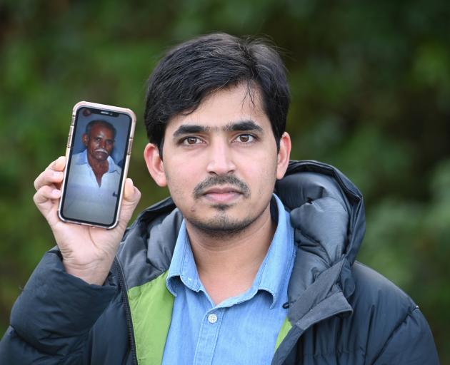 Aged care sector worker Tej Prakash, of Dunedin, with a photo of his father 
...