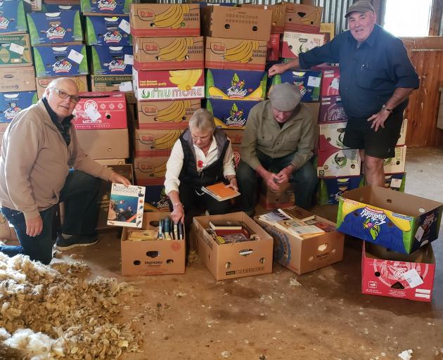 Organising books for the Rotary Club of Taieri's upcoming book sale are (from left) Phil Farquar,...