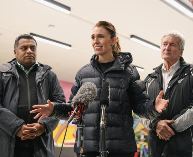Prime Minister Jacinda Ardern, flanked by Acting Emergency Management Minister Kris Faafoi and...