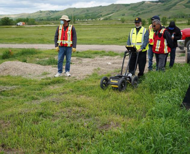 A crew performing a ground-penetrating radar search of a field, where the Cowessess First Nation...