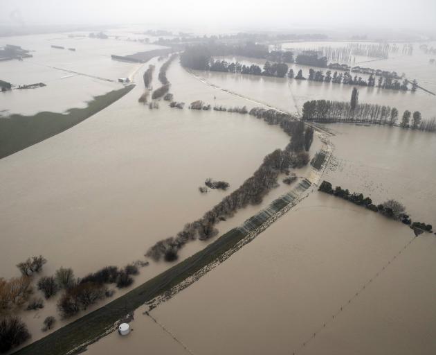 Floodwaters cover large tracts of land around the Selwyn River yesterday. Photo: The New Zealand...