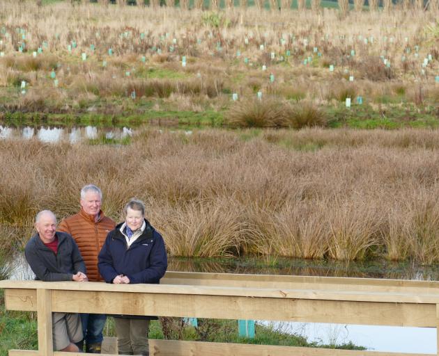Standing overlooking the new Waipahi Wetland are (from left) project manager Shane Bocock, and...