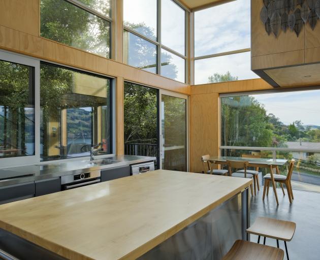 The kitchen opens to a deck surrounded by native bush. Almost all furniture, including the...
