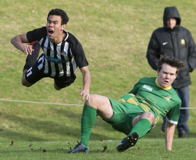 Northern’s Mateo Savou goes flying after being tackled by Green Island’s Cam Brewitt in a Chatham...