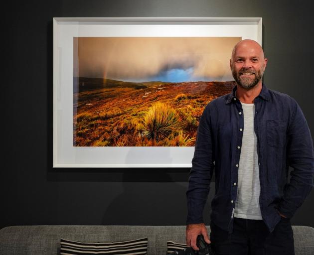 Christopher Thompson exhibits one of his photos from the trip in his Picture Lounge studio. PHOTO...