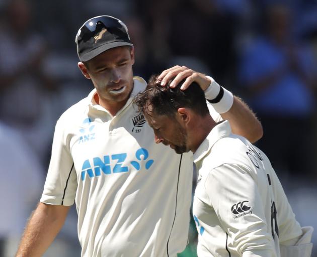 Tim Southee congratulates Devon Conway for reaching a double century after the innings Action...