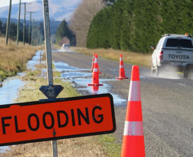 A sign warns of flooding on the Arundel Rakaia Gorge Rd, Inland Scenic Route 72. PHOTO: TONI...
