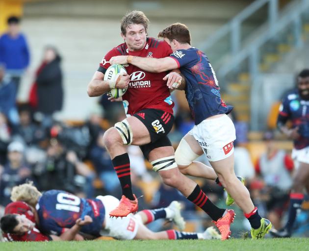 Ethan Blackadder of the Crusaders is brought down during their 52-26 win over the Rebels in...