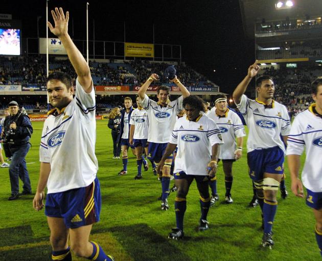 Captain Taine Randell leads the Highlanders off Eden Park in 2002 after claiming the first win at...