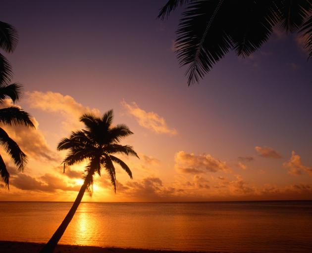 Sunset on Aitutaki lagoon. Photo: Getty Images