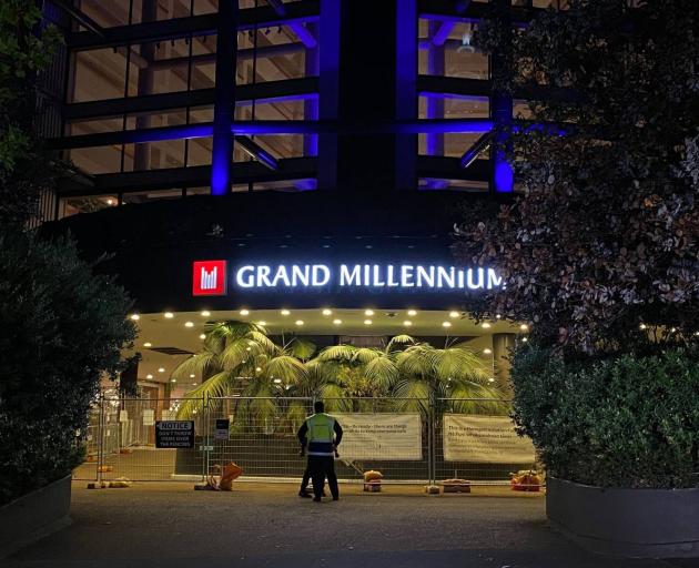 There is a noticeable security presence outside the hotel this morning, with two guards wearing masks at the entrance. Photo / William Terite