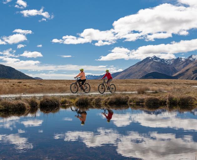 Two cyclists ride around a pond in Kingston earlier this year. PHOTOS: SUPPLIED