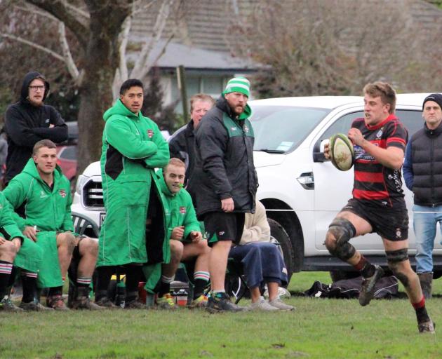 Christchurch's Nathan Evans makes a break past unimpressed Marist Albion reserves. Photo:...