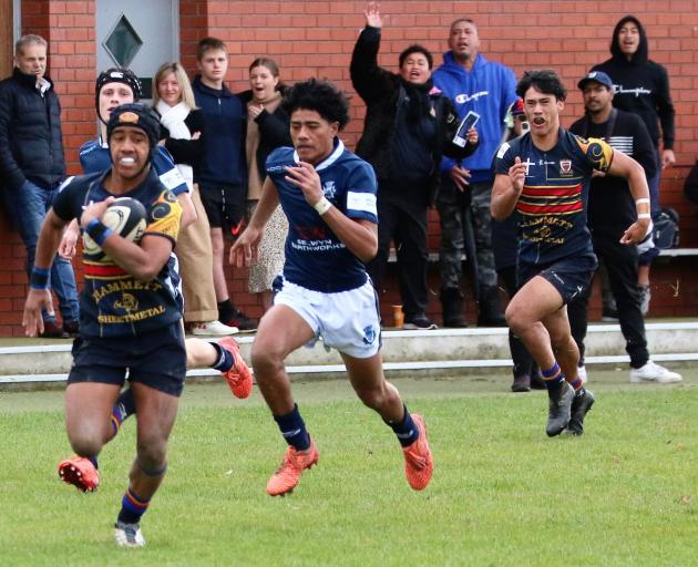 St Thomas' Simon Uliano heads for the line to open the scoring at St Andrew's College after...